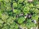Aerial view of a secluded home nestled amongst a canopy of green trees, offering privacy and natural beauty at 80 Stratford Ne Pl, Atlanta, GA 30342