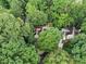 Secluded home nestled among mature trees, featuring a long driveway and charming curb appeal at 80 Stratford Ne Pl, Atlanta, GA 30342