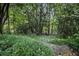 Lush backyard featuring stone steps leading through a tranquil garden, perfect for nature lovers at 80 Stratford Ne Pl, Atlanta, GA 30342