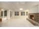 Basement with a stone fireplace and access to the backyard through glass doors and large windows at 80 Stratford Ne Pl, Atlanta, GA 30342