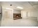 Finished basement space with a stone fireplace, tile floors, and recessed lighting at 80 Stratford Ne Pl, Atlanta, GA 30342
