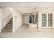 A bright basement with tile flooring, a staircase, and double doors leading to the exterior at 80 Stratford Ne Pl, Atlanta, GA 30342