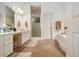 Bright bathroom with double sink vanity, walk-in shower, and soaking tub at 80 Stratford Ne Pl, Atlanta, GA 30342