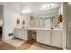 Bathroom features a large mirror, vanity with double sinks, bright lighting, and an elegant, neutral color palette at 80 Stratford Ne Pl, Atlanta, GA 30342
