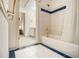 Bathroom features tiled shower-tub, and view to an open door, revealing a glimpse of the bedroom beyond at 80 Stratford Ne Pl, Atlanta, GA 30342