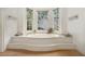 Bathroom featuring a garden tub set beneath a bright bay window at 80 Stratford Ne Pl, Atlanta, GA 30342