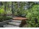 Secluded garden nook with a brick terrace, stone steps, and wrought iron bench, perfect for peaceful contemplation at 80 Stratford Ne Pl, Atlanta, GA 30342