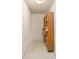 Hallway with neutral tile floor, white walls, and built-in shelving for storage at 80 Stratford Ne Pl, Atlanta, GA 30342