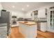 Bright kitchen with stainless steel appliances, a center island, and tile backsplash at 80 Stratford Ne Pl, Atlanta, GA 30342