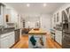 Kitchen with a butcher block island, stainless steel appliances, and white cabinets at 80 Stratford Ne Pl, Atlanta, GA 30342