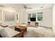 Bright living room with a ceiling fan and natural light from the windows overlooking the backyard at 80 Stratford Ne Pl, Atlanta, GA 30342