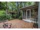 Charming brick patio with a pergola, surrounded by lush greenery, creating a serene outdoor retreat at 80 Stratford Ne Pl, Atlanta, GA 30342