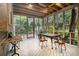 Inviting screened porch with ceiling fan, a perfect spot to relax and dine while enjoying the beautiful garden views at 80 Stratford Ne Pl, Atlanta, GA 30342