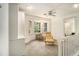 Comfortable sitting area with a bay window, ceiling fan, and natural light, with a glimpse of the bedroom at 80 Stratford Ne Pl, Atlanta, GA 30342