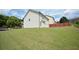 Wide shot of a large, grassy backyard with fencing and other houses visible in the background at 829 Still Hill Ln, Lawrenceville, GA 30045