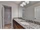 Bathroom features a granite vanity top and tiled floor with shower and tub at 829 Still Hill Ln, Lawrenceville, GA 30045