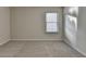 Bedroom featuring neutral-colored carpet, a window, and white walls at 829 Still Hill Ln, Lawrenceville, GA 30045