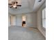 Spacious bedroom with tray ceiling, plush carpet, and easy access to the ensuite bathroom at 829 Still Hill Ln, Lawrenceville, GA 30045