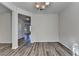 Bright dining room featuring wood flooring, chandelier lighting and hallway at 829 Still Hill Ln, Lawrenceville, GA 30045