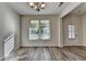 Bright dining room featuring wood flooring, chandelier lighting and door to the outside at 829 Still Hill Ln, Lawrenceville, GA 30045