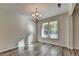 A dining room with hardwood floors, chandelier, and large window with outside views at 829 Still Hill Ln, Lawrenceville, GA 30045