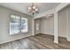 Bright dining room featuring wood flooring, chandelier lighting and doorway at 829 Still Hill Ln, Lawrenceville, GA 30045
