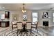 Dining room featuring fireplace, art and a modern chandelier at 829 Still Hill Ln, Lawrenceville, GA 30045