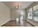 Bright dining room featuring wood flooring, chandelier lighting and large window allowing for natural light at 829 Still Hill Ln, Lawrenceville, GA 30045