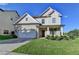 Charming two-story home featuring a brick facade, well-manicured lawn, and an attached two-car garage at 829 Still Hill Ln, Lawrenceville, GA 30045