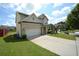 Lovely two-story home with a well-maintained lawn and a long driveway leading to the attached garage at 829 Still Hill Ln, Lawrenceville, GA 30045