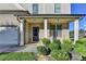 Inviting home entrance with a brick facade, decorative columns, and manicured landscaping at 829 Still Hill Ln, Lawrenceville, GA 30045