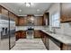 Modern kitchen features dark wood cabinets and stainless steel appliances at 829 Still Hill Ln, Lawrenceville, GA 30045