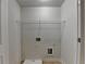 Utility room with laundry hookups and a wire shelf for organizing your space at 829 Still Hill Ln, Lawrenceville, GA 30045