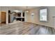 Living room features gray flooring, view to the kitchen, and door to the backyard at 829 Still Hill Ln, Lawrenceville, GA 30045