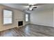 Bright living room featuring a fireplace, two large windows and a ceiling fan at 829 Still Hill Ln, Lawrenceville, GA 30045