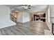 Bright open-concept living room with gray flooring, fireplace and kitchen at 829 Still Hill Ln, Lawrenceville, GA 30045