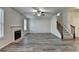 Spacious living room featuring a fireplace, staircase and plenty of natural light at 829 Still Hill Ln, Lawrenceville, GA 30045