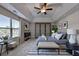 Stylishly staged main bedroom features a tray ceiling, plush carpet, and ample natural light at 829 Still Hill Ln, Lawrenceville, GA 30045