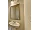 Pedestal sink and framed mirror enhance this well-lit, convenient powder room at 829 Still Hill Ln, Lawrenceville, GA 30045