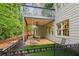 Inviting backyard patio featuring a shaded sitting area, lush landscaping, and a cozy atmosphere for outdoor enjoyment at 878 Treadstone Overlook, Suwanee, GA 30024