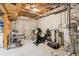 Partially finished basement equipped with home gym, exercise equipment, and exposed utilities, ideal for fitness enthusiasts at 878 Treadstone Overlook, Suwanee, GA 30024