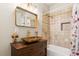 Bathroom showcasing unique vessel sink, stylish mirror, tiled shower, and tub at 878 Treadstone Overlook, Suwanee, GA 30024