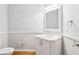 Bathroom with wood floors, white walls, toilet, vanity, towel rack and a square mirror at 878 Treadstone Overlook, Suwanee, GA 30024