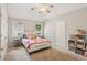 Bright bedroom with a vaulted ceiling, two windows, beige carpet, and a comfortable bed with pink accents at 878 Treadstone Overlook, Suwanee, GA 30024