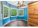 Bonus room with a blue wall, a wood accent wall, and bright windows at 878 Treadstone Overlook, Suwanee, GA 30024