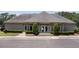 The community clubhouse with inviting entrance, trimmed evergreens, and ample parking at 878 Treadstone Overlook, Suwanee, GA 30024