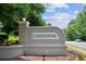 Welcoming Lansdowne community entrance sign, set among lush landscaping on a sunny day at 878 Treadstone Overlook, Suwanee, GA 30024