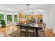Open concept dining area next to the kitchen features a large table and chairs with hardwood floors at 878 Treadstone Overlook, Suwanee, GA 30024