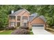 Charming brick home with well-maintained landscaping and attached two-car garage at 878 Treadstone Overlook, Suwanee, GA 30024