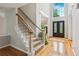 Grand foyer with hardwood floors, staircase, and large window at 878 Treadstone Overlook, Suwanee, GA 30024